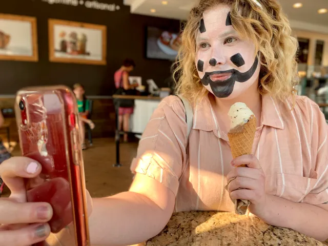 blonde juggalo woman taking a selfie inside a restuarant.webp