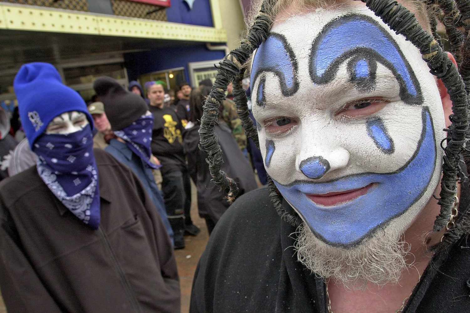 insane clown posse juggalo with blue themed makeup taking a selfie with a friend wearing a blue beanie.jpg