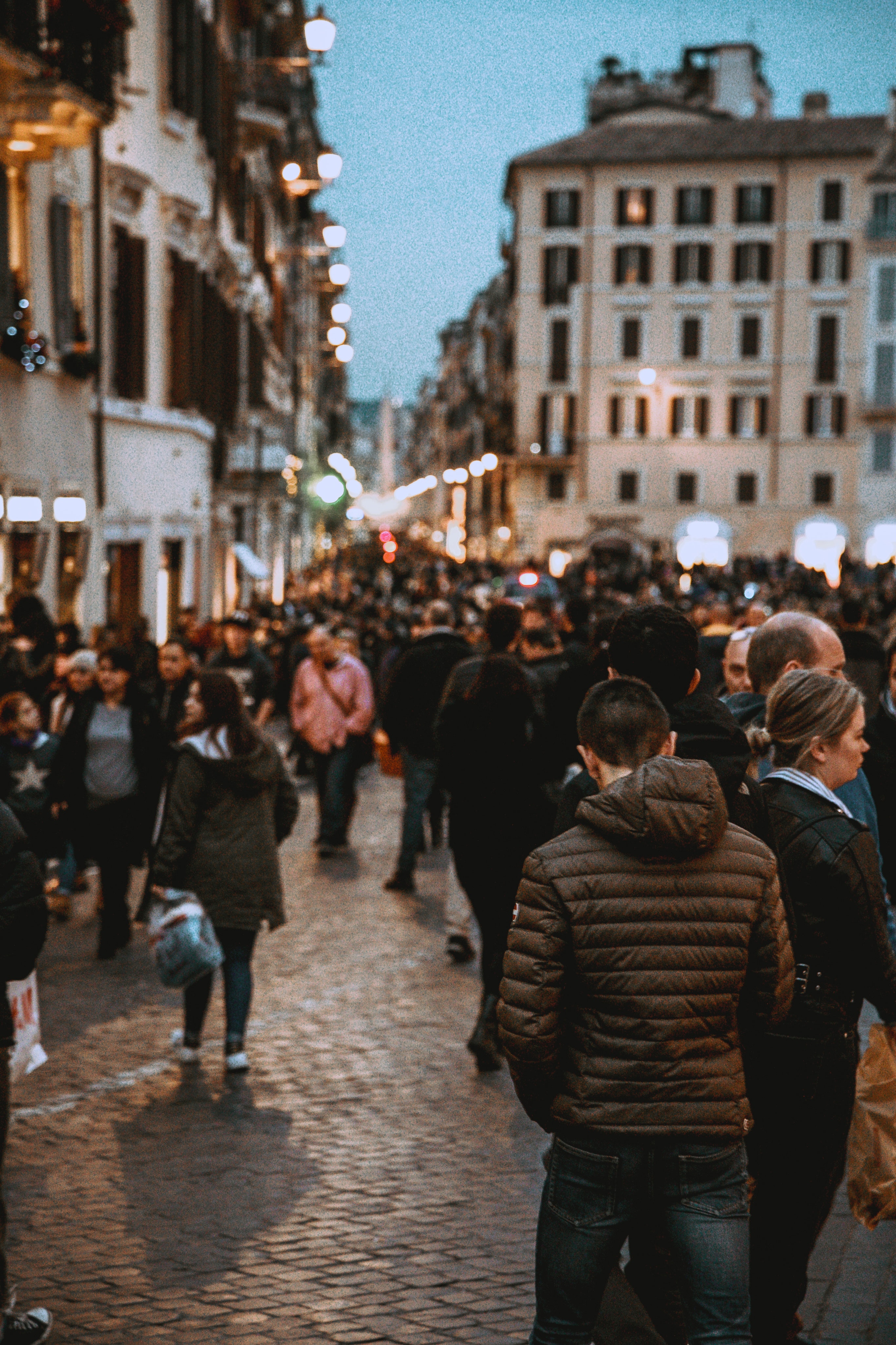 source_a_man_wearing_a_brown_hoodie_in_a_crowded_street.jpeg